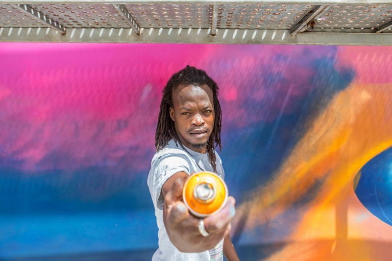 Beninese artist Laurenson Djihouessi, known as Mr Stone, during the Graff Effect festival in Cotonou, on May 18, 2022 in Benin (AFP - YANICK FOLLY)